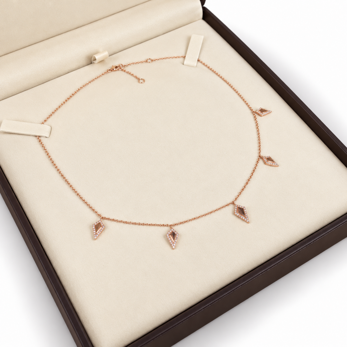 14K rose gold five kite charm necklace with natural diamonds presented in an ivory jewelry gift box.