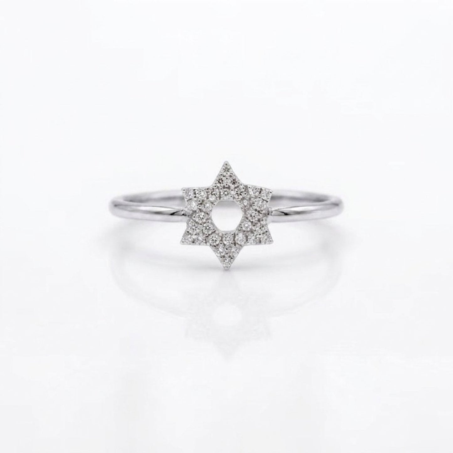 A silver ring featuring a six-pointed star design paved with small clear diamonds, set against a clean white background with a soft reflection.