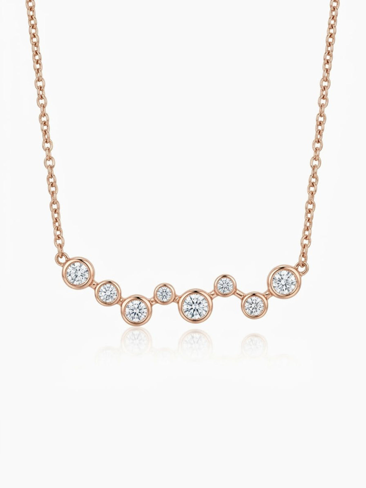 Solid 14K rose gold diamond necklace with eight graduated bezel-set natural diamonds, approximately 0.40 CTW, and an adjustable 15-17 inch chain.