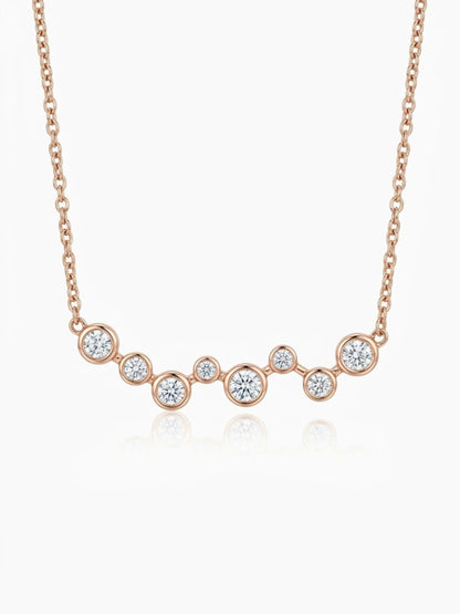 Solid 14K rose gold diamond necklace with eight graduated bezel-set natural diamonds, approximately 0.40 CTW, and an adjustable 15-17 inch chain.