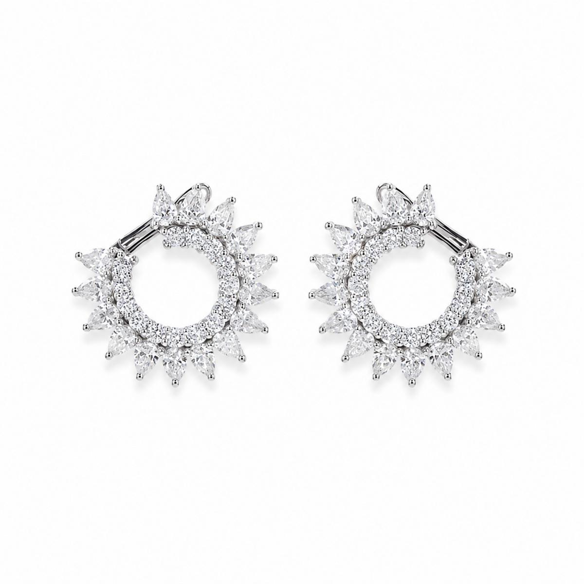 A pair of silver-toned hoop earrings with a sunburst halo design, set with clear marquise-cut and round-cut  diamonds., shown on a plain white background.