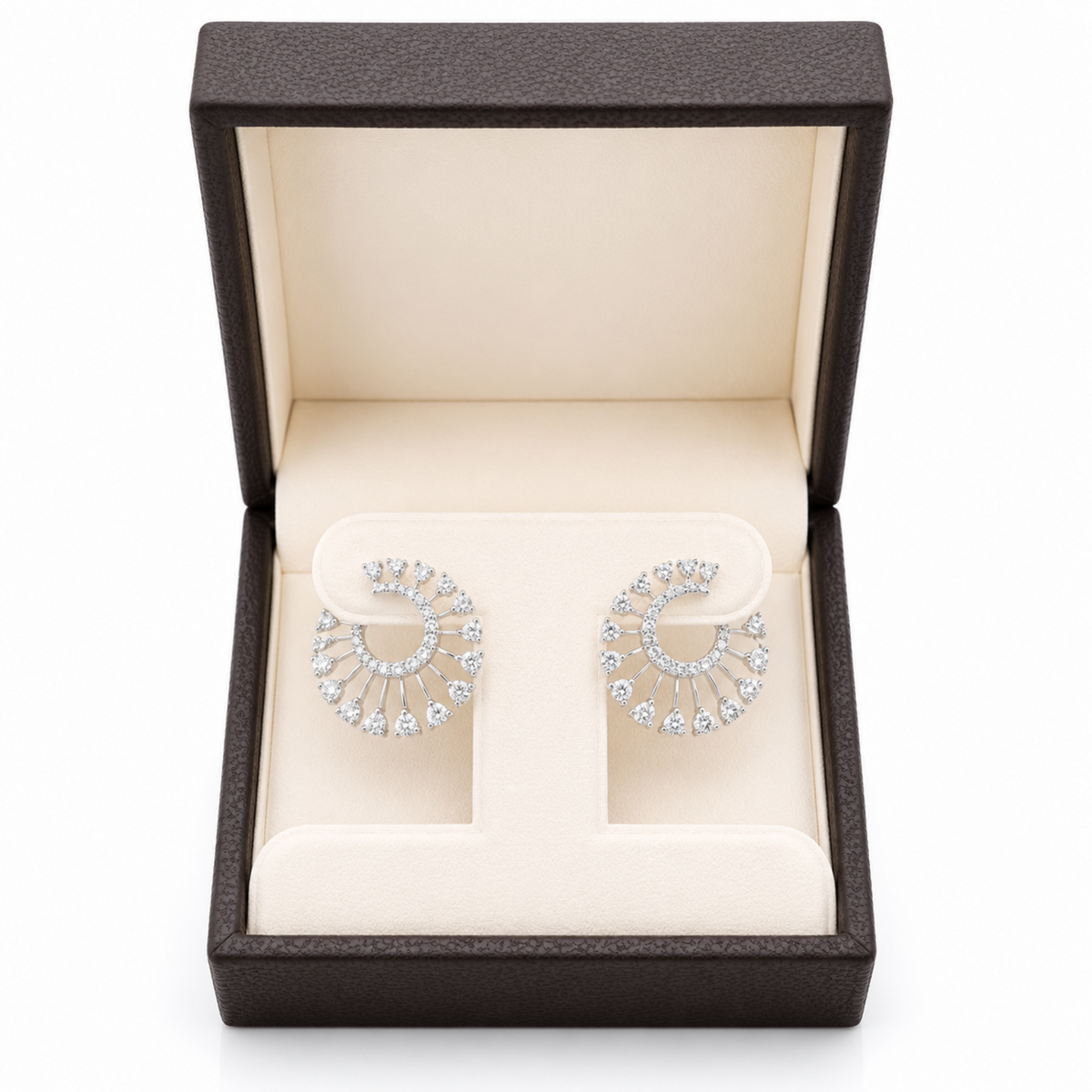 A pair of silver crescent-shaped stud earrings set with clear diamonds, presented in an open dark brown textured jewelry box with a cream-colored interior.