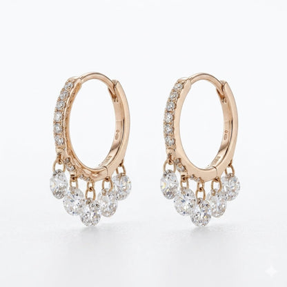 A pair of rose gold huggie hoop earrings with dangling clusters of clear round-cut diamonds, shown on a clean white background.