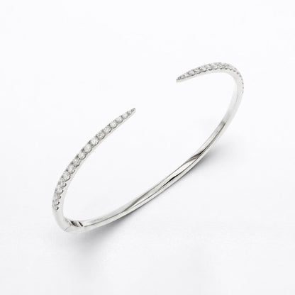 A polished silver-tone open cuff bangle bracelet with delicate rows of clear pavé diamonds along both open ends, displayed on a clean white background.
