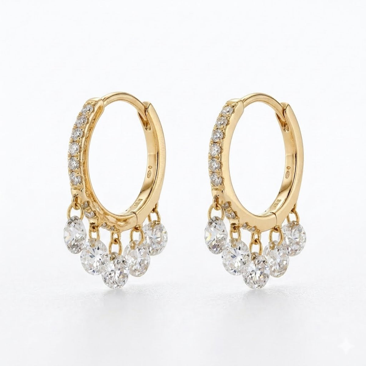 A pair of gold huggie hoop earrings with rows of small clear diamonds along the front and five dangling clear round diamonds at the bottom, shown on a clean white background.