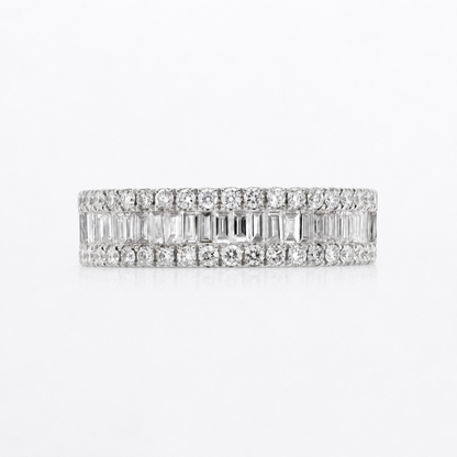 A diamond eternity band ring in white gold or platinum, featuring rows of round and baguette-cut diamonds, shown on a clean white background.