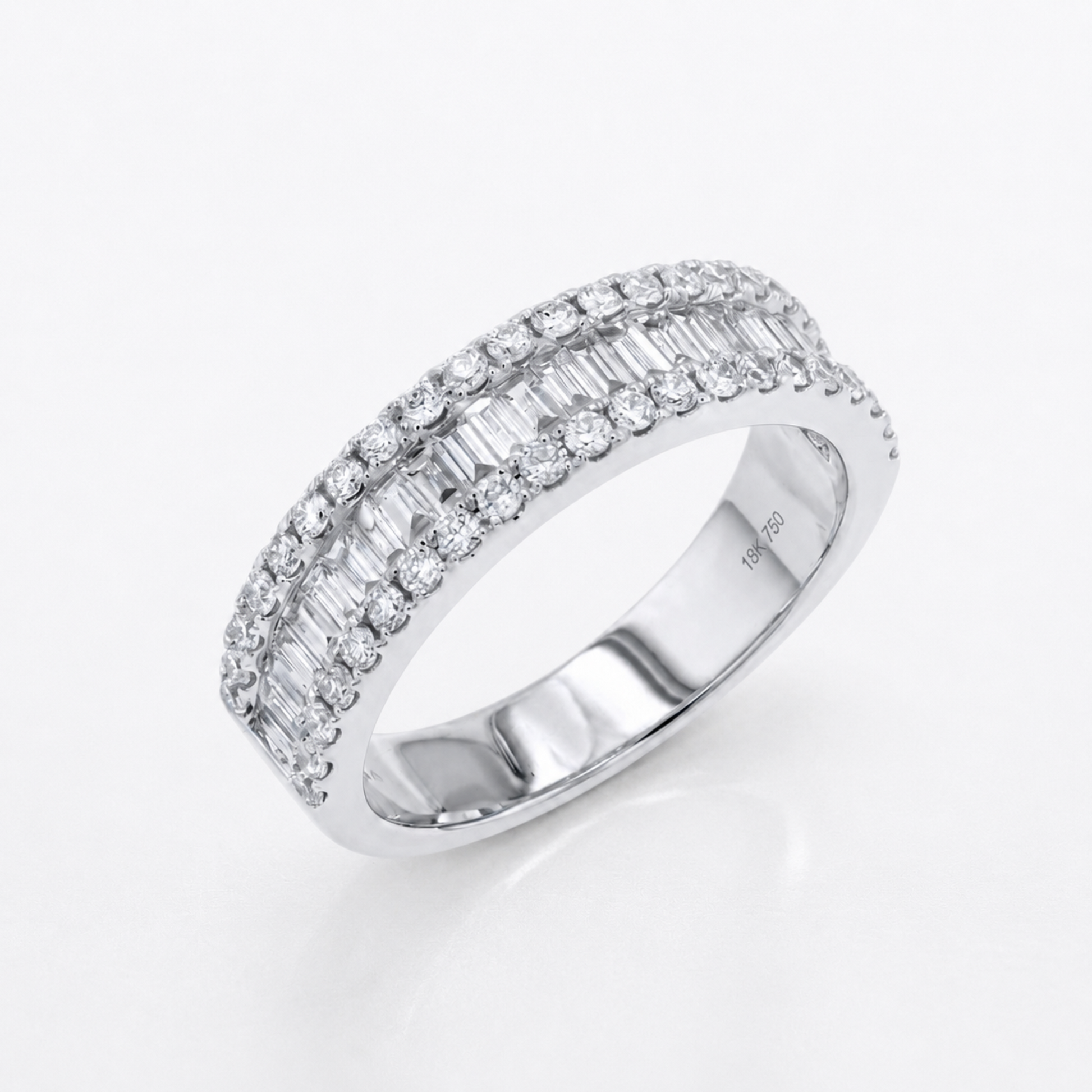 A silver-tone diamond ring with two rows of baguette and round-cut diamonds, shown on a clean white background.