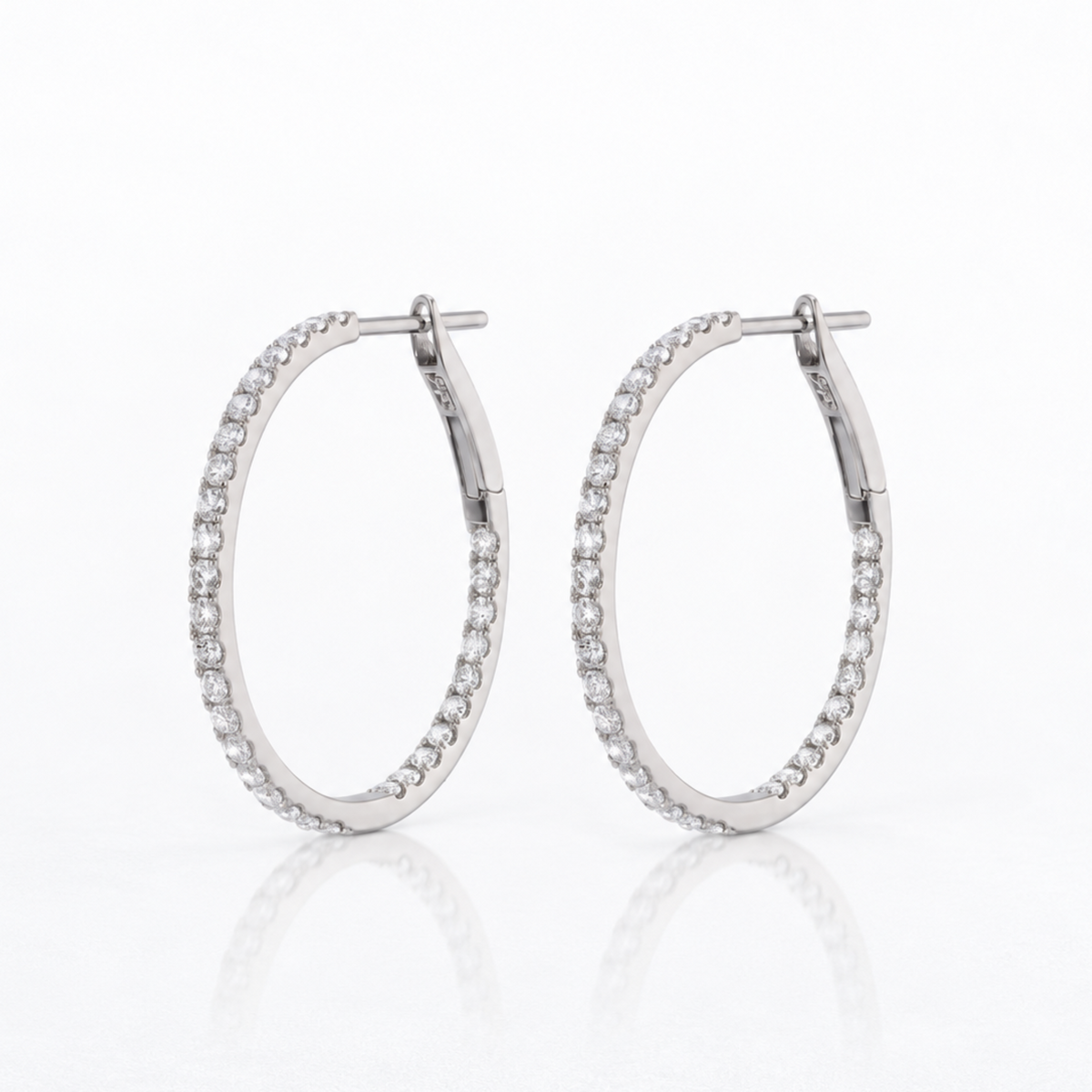 Pair of 1-inch natural diamond inside-out hoop earrings in solid 18K white gold, set with round brilliant diamonds.