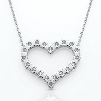 A silver heart-shaped pendant necklace with a scalloped edge and small clear rhinestones, suspended from a delicate silver chain on a white background with a soft reflection.