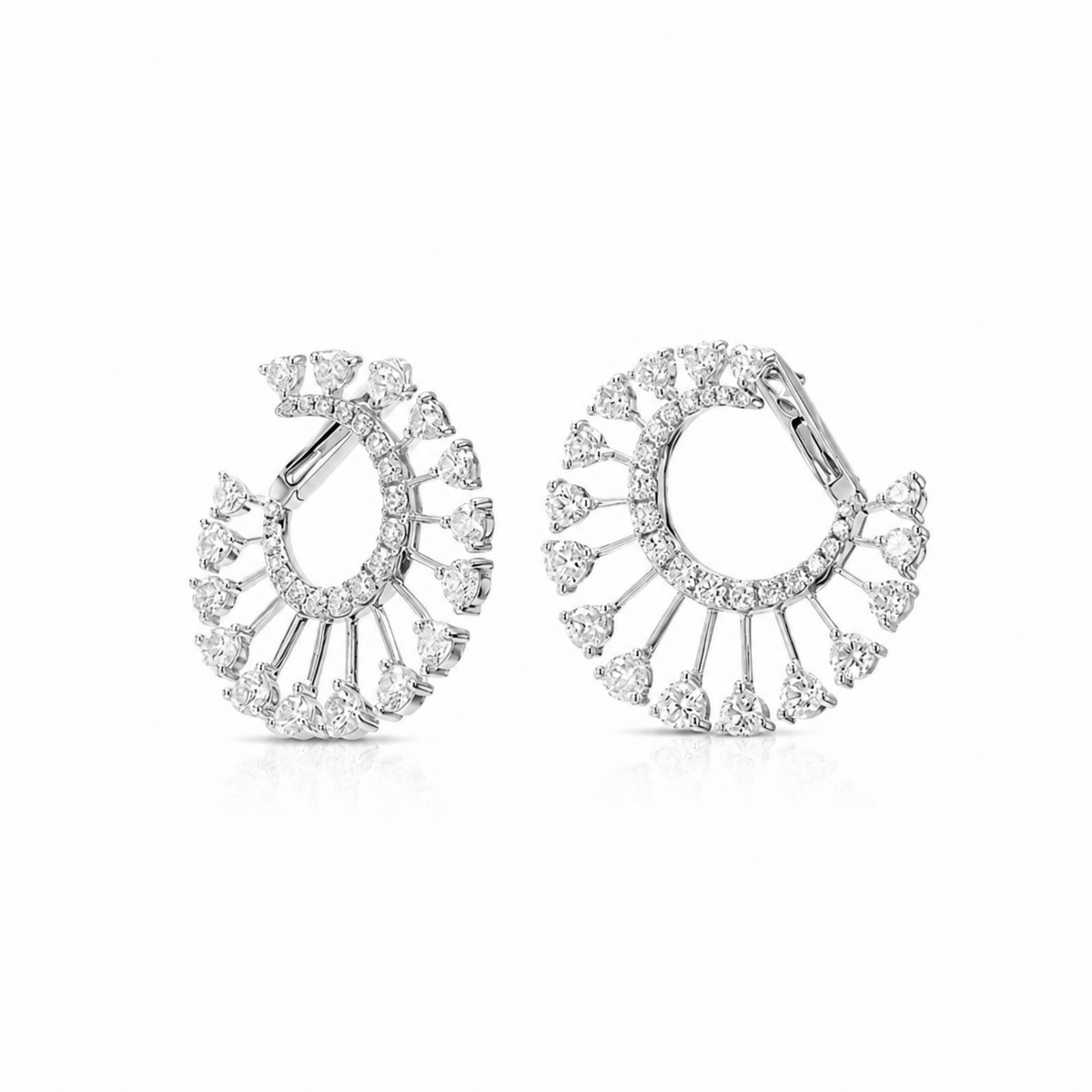A pair of silver-toned hoop earrings adorned with multiple clear diamonds arranged in a fan or sunburst pattern, shown on a clean white background.
