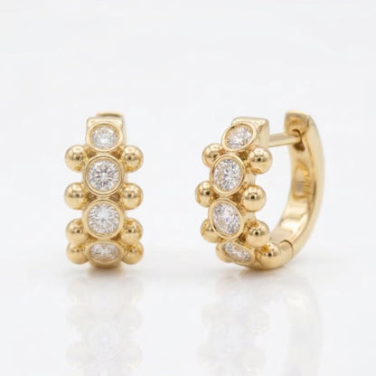18K yellow gold Orbi Collection natural diamond bezel and gold bead huggie earrings, front and angled view