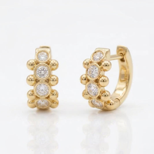 18K yellow gold Orbi Collection natural diamond bezel and gold bead huggie earrings, front and angled view