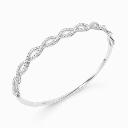 A silver-toned bangle bracelet featuring an intricate twisted openwork design paved with small cleardiamonds, shown on a clean white background.