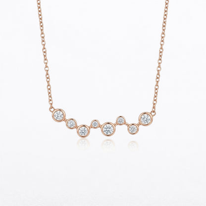 14K rose gold graduated bezel-set natural diamond necklace featuring eight round brilliant diamonds totaling 0.40 carats on an adjustable gold chain.