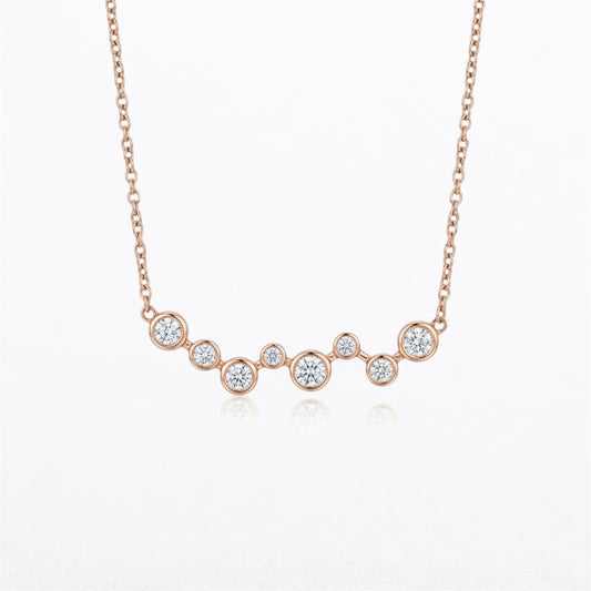 14K rose gold graduated bezel-set natural diamond necklace featuring eight round brilliant diamonds totaling 0.40 carats on an adjustable gold chain.
