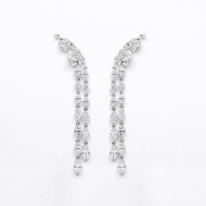 A pair of silver-tone drop earrings adorned with marquise diamonds, arranged symmetrically on a plain white background.