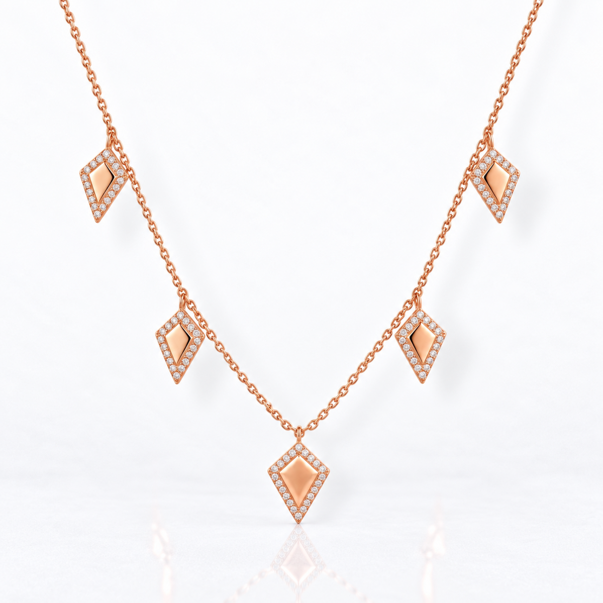 Full view of 14K rose gold five kite charm necklace with natural diamonds and adjustable cable chain.