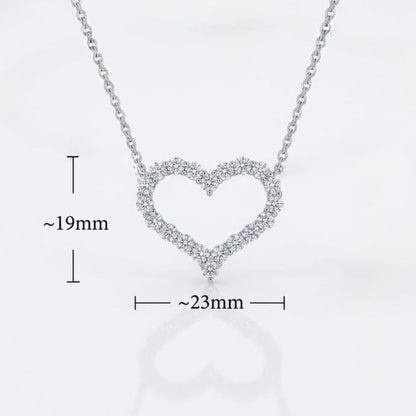 Silver heart-shaped open pendant necklace with tiny cleardiamonds, shown on a white background with dimension markers indicating approximately 19mm height and 23mm width.