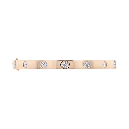 A slim rose gold bracelet featuring seven bezel-set round clear diamonds, shown against a plain white background.