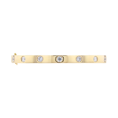 A yellow gold bar bracelet with five bezel-set round clear diamonds, displayed horizontally on a solid white background.
