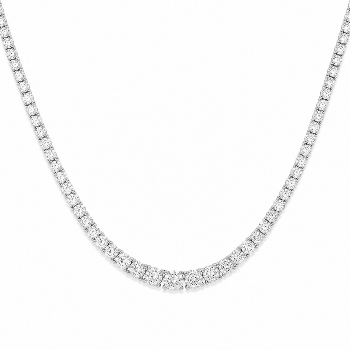 A silver tennis necklace paved with small round-cut clear diamonds, shown against a plain white background.