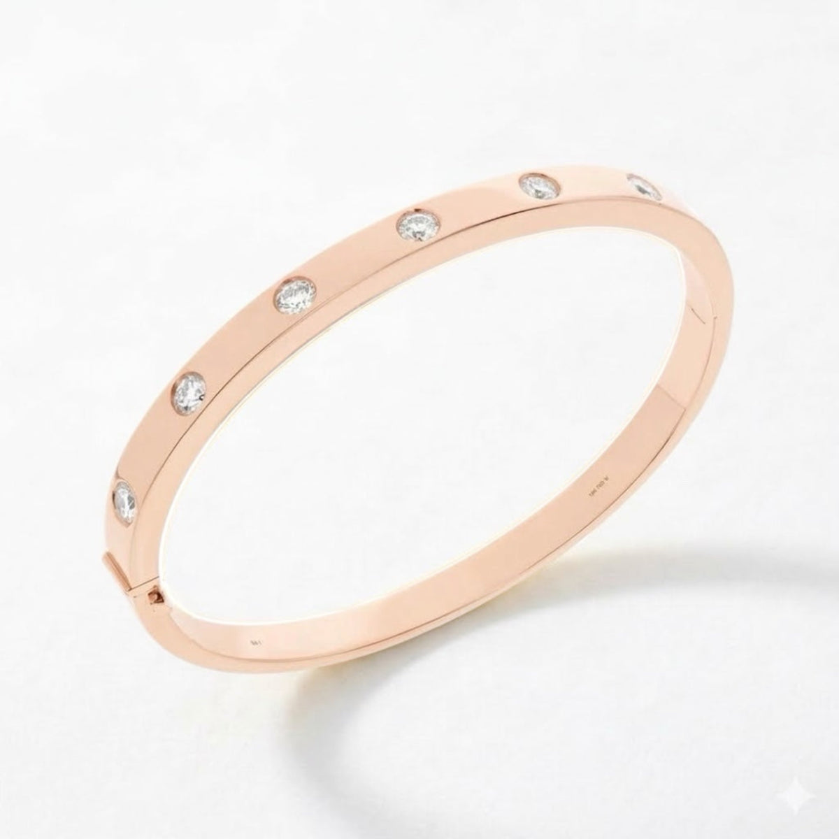 A rose gold bangle bracelet with a continuous band and small, evenly spaced clear round-cut diamonds, shown on a clean white background.
