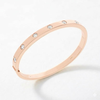 A rose gold bangle bracelet with a continuous band and small, evenly spaced clear round-cut diamonds, shown on a clean white background.