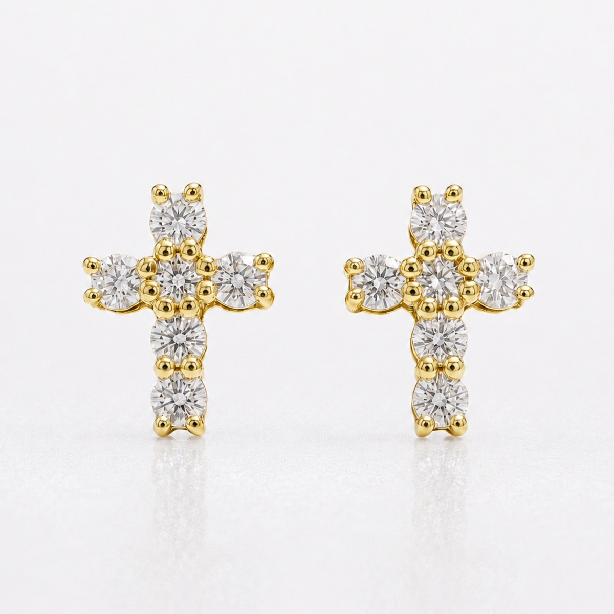 Pair of yellow gold natural diamond cross stud earrings