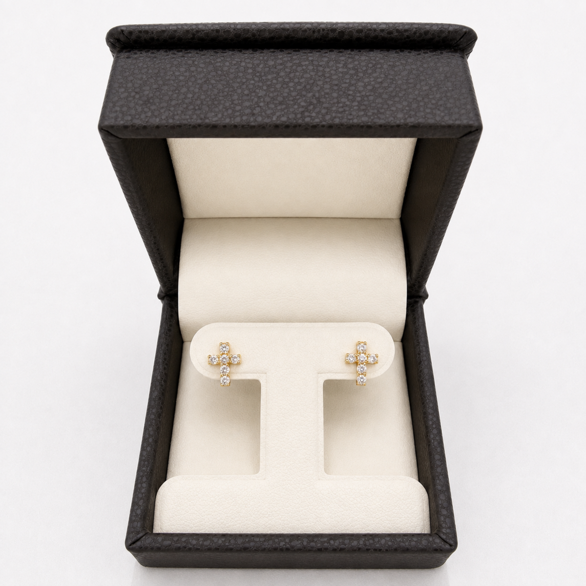 Yellow gold natural diamond cross stud earrings displayed in jewelry box