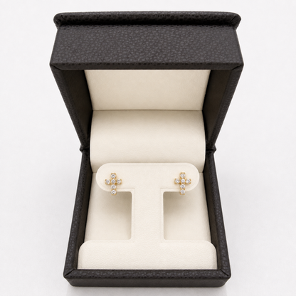 Yellow gold natural diamond cross stud earrings displayed in jewelry box