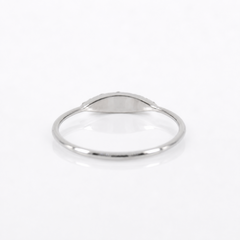 A minimalist silver signet ring with a smooth, polished oval face, displayed on a clean white background.