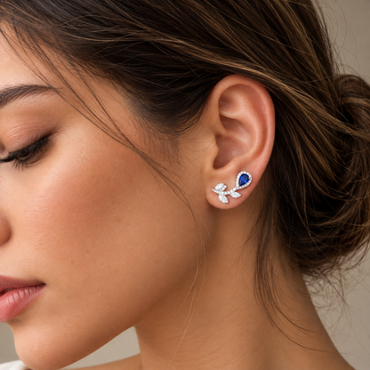 Model wearing 20mm natural blue sapphire and diamond floral ear climber earrings in 18K white gold
