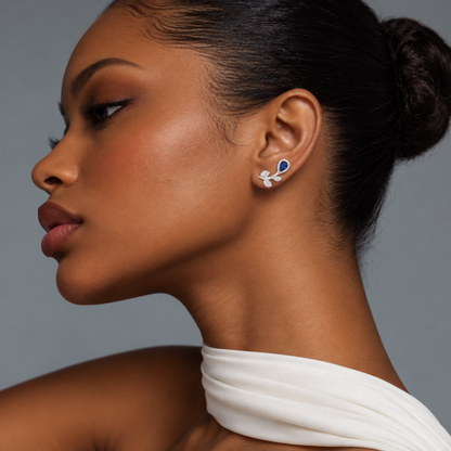 Side profile of model wearing natural blue sapphire and diamond floral ear climber earrings in 18K white gold