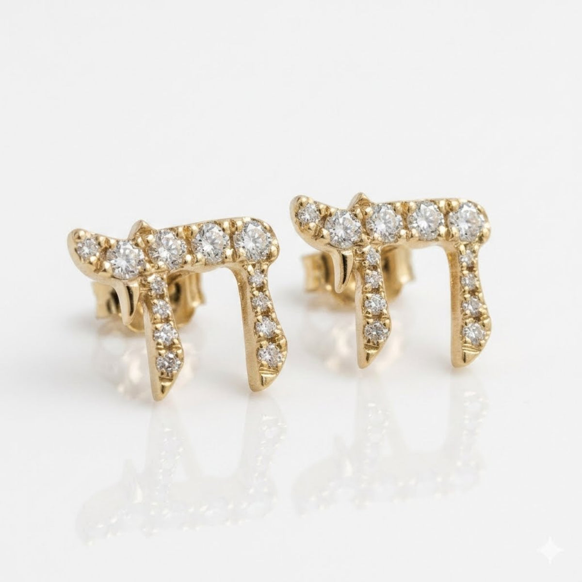 A pair of gold Chai stud earrings set with clear round diamonds, displayed on a clean white reflective surface.