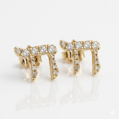 A pair of gold Chai stud earrings set with clear round diamonds, displayed on a clean white reflective surface.