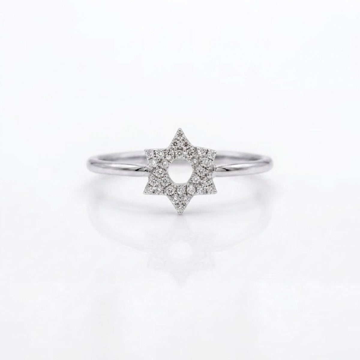 A silver ring featuring a six-pointed star design paved with small clear diamonds, set against a clean white background with a soft reflection.