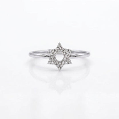 A silver ring featuring a six-pointed star design paved with small clear diamonds, set against a clean white background with a soft reflection.