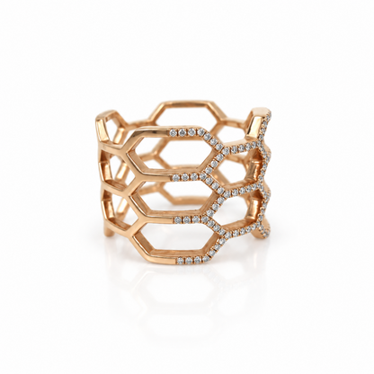A rose gold geometric openwork ring with pavé-set diamonds, displayed on a clean white background with a soft reflection.