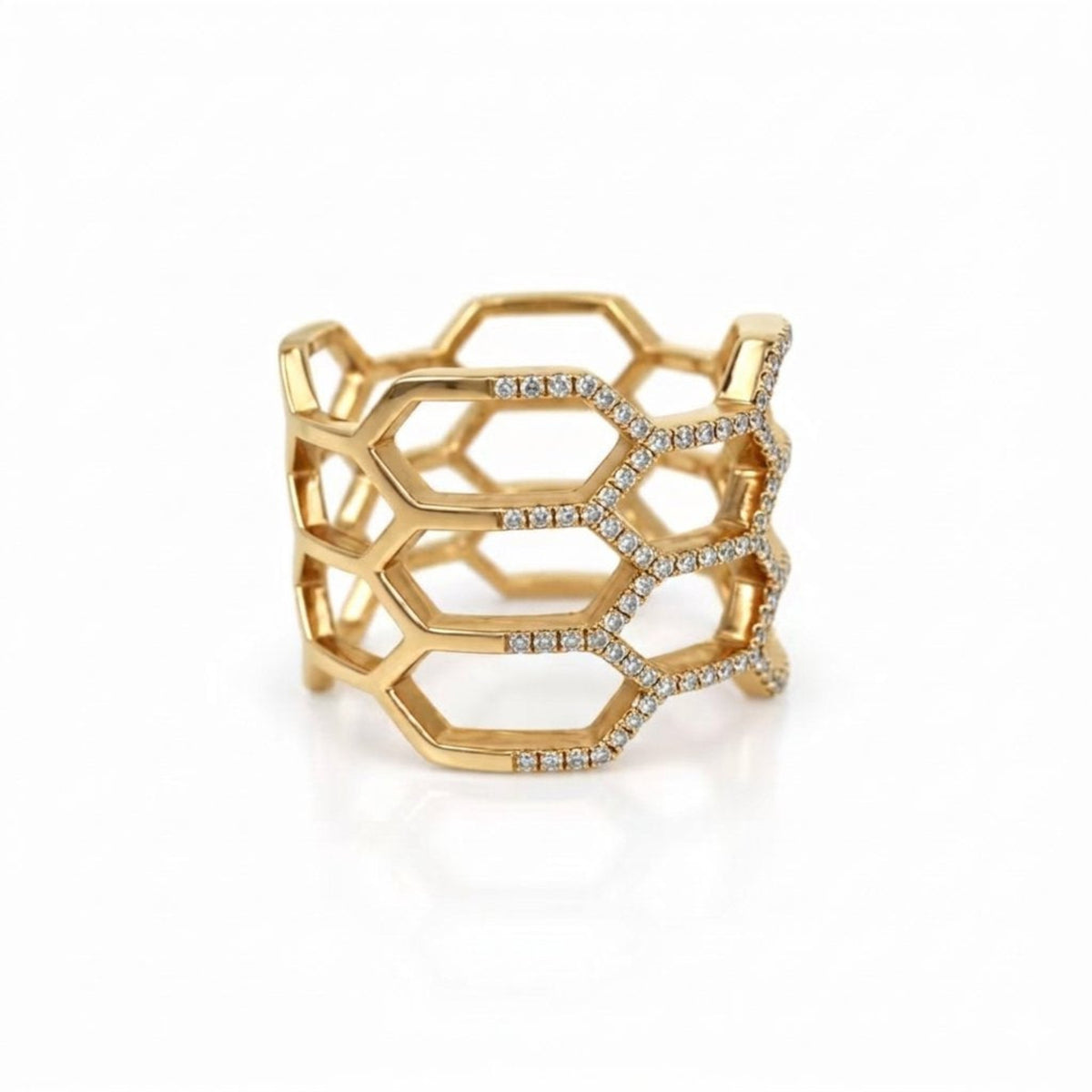 A gold geometric openwork ring with pavé-set clear diamonds, photographed on a clean white background.