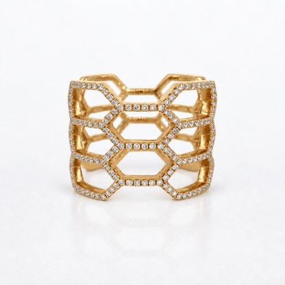 A gold geometric openwork cuff ring embellished with rows of small diamonds, photographed on a clean white background.