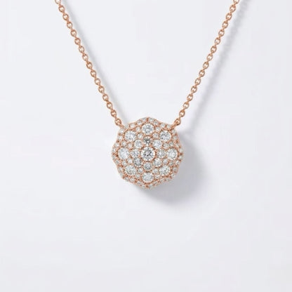 A rosevgold chain necklace with a round pavé pendant set with clear diamonds, shown on a clean white background.