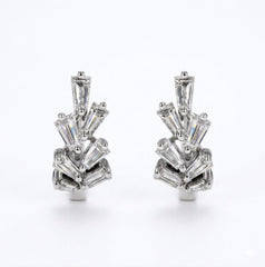 A pair of silver-tone geometric stud earrings featuring baguette-cut clear diamonds arranged in a fan or burst pattern, set against a plain white background.