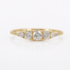 A yellow gold diamond ring with five round-cut diamonds set in a marquise-shaped arrangement on a polished band, photographed on a clean white background.