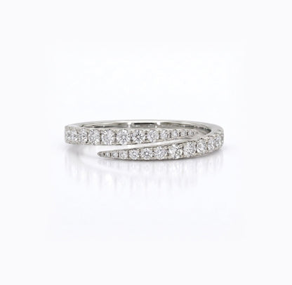 A silver wrap ring featuring pavé-set round diamonds on both bands, photographed on a clean white background with a soft reflection.