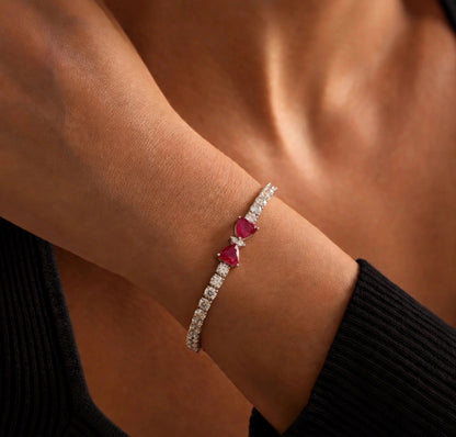 Model wearing 7-inch natural ruby and diamond bow tennis bracelet in 18K white gold