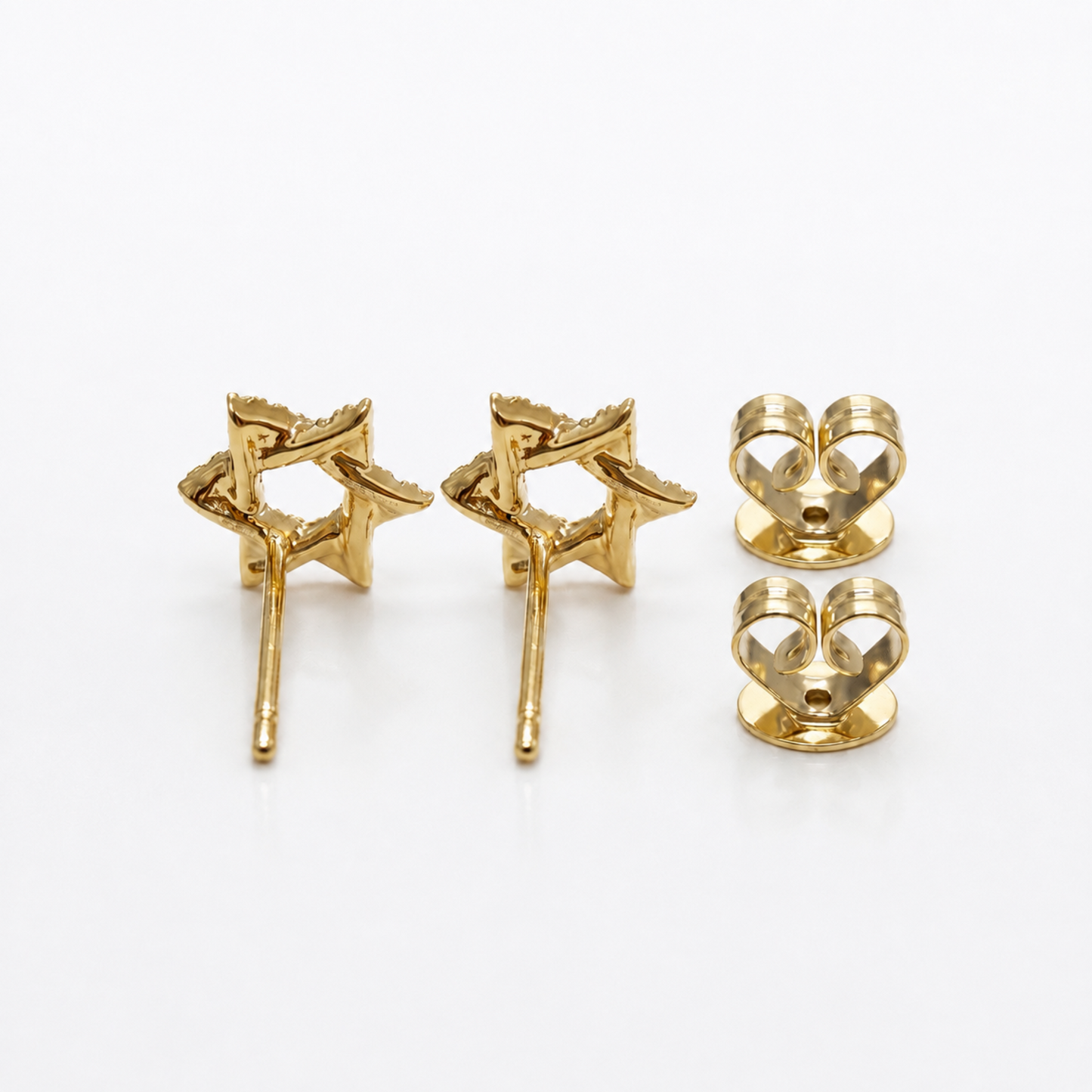 A pair of gold star-shaped stud earrings shown from the back next to two matching backings on a clean white background.