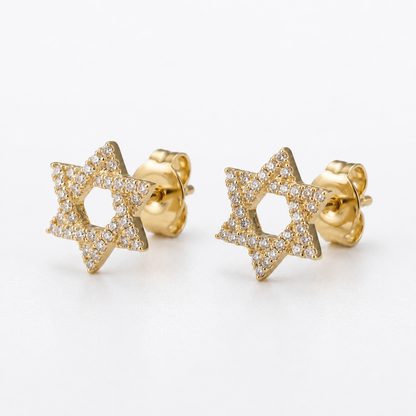 A pair of gold Star of David stud earrings paved with small clear diamonds, displayed on a clean white background.