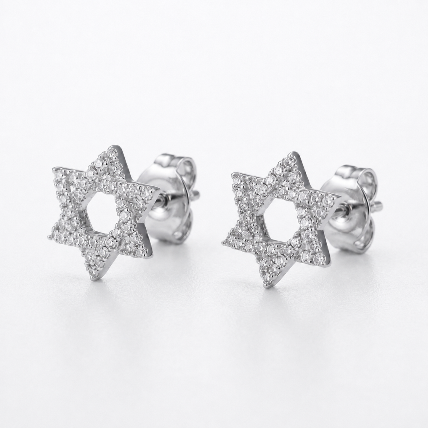 A pair of silver Star of David stud earrings paved with small diamonds, shown on a clean white background.