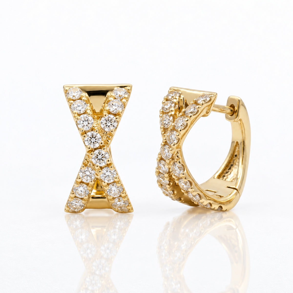 14K yellow gold natural diamond X huggie earrings 12MM photographed at an angle showing the diamond-set fronts and polished gold hoops.
