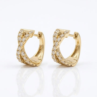 Side view of 14K yellow gold natural diamond X huggie hoop earrings showing the curved hoop design and diamond settings.